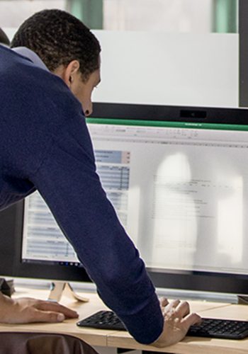Coworkers in a modern office Cowerkers looking at notebook in a modern office