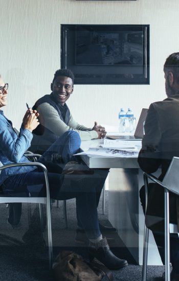Coworkers in a modern office Cowerkers looking at notebook in a modern office
